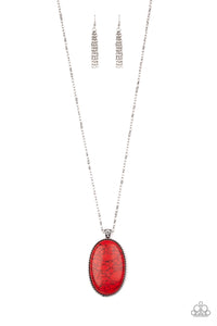 Chiseled into a tranquil oval, a dramatically oversized red stone pendant swings from the bottom of a lengthened silver chain. Glassy white rhinestones dust the pendant's fitting for a refined flair. Features an adjustable clasp closure.