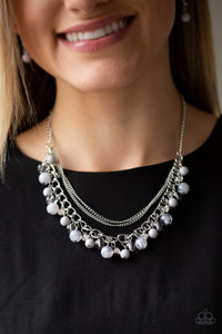 Infused with layers of mismatched silver chains, glassy, polished gray, and glittery white rhinestones swing from the bottom of a bold silver chain, creating a bubbly fringe below the collar. Features an adjustable clasp closure.