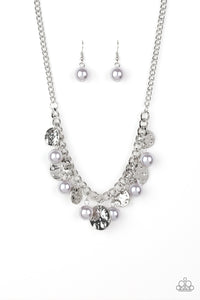 A collection of hammered silver discs and pearly silver beads swing from a thick silver chain, creating an elegant fringe below the collar. Features an adjustable clasp closure.
