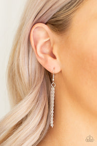 Cut into a striking triangular shape, a faceted smoky gem swings from the bottom of a lengthened silver chain for an edgy-glamorous fashion. Features an adjustable clasp closure.