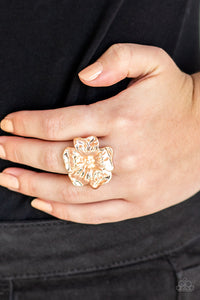 Brushed in a high-sheen shimmer, glistening rose gold petals fold into a tropical inspired flower atop the finger for a seasonal flair. Features a stretchy band for a flexible fit.