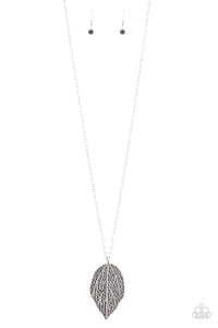 Featuring lifelike patterns, a hematite rhinestone encrusted silver leaf swings from the bottom of a lengthened silver chain, creating an edgy pendant. Features an adjustable clasp closure.