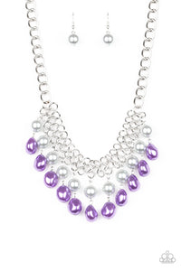 A collection of classic and imperfect silver and purple pearls dangle from a web of interlocking silver links below the collar, adding a modern twist to the timeless palette. Features an adjustable clasp closure.