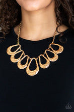 Load image into Gallery viewer, Delicately hammered in shimmer, a collection of shiny gold teardrops link below the collar for an edgy statement-making look. Features an adjustable clasp closure.
