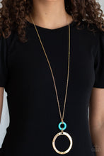 Load image into Gallery viewer, Featuring a delicately hammered finish, an oversized gold hoop links with a refreshing turquoise stone ring at the bottom of a lengthened gold chain for a sophisticated look. Features an adjustable clasp closure.
