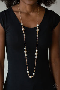 Capped in ornate gold frames, a collection of bubbly white pearls and glistening gold beads trickle along sections of shiny gold chain across the chest for a timeless sophistication. Features an adjustable clasp closure.