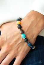 Load image into Gallery viewer, A refreshing compilation of shiny black beads, silver accents, and earthy stone beads are threaded along a stretchy band around the wrist for a seasonal look.
