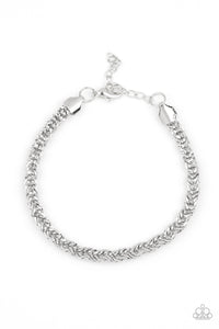 Brushed in a high-sheen finish, an ornate silver chain links around the wrist for a bold look. Features an adjustable clasp closure.