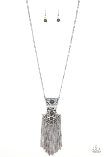 Dotted with earthy green stone accents and swirling with tribal inspired details, stacked silver frames link at the bottom of a lengthened silver chain. Shimmery silver chains stream from the bottom of the bold pendant, creating vivacious movement. Features an adjustable clasp closure.