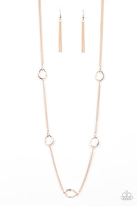 Glassy white teardrops attach to sections of rose gold chain across the chest, creating a refined display. Features an adjustable clasp closure.