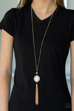 Load image into Gallery viewer, Encased in a frame of dazzling white rhinestones, a glowing white cat&#39;s eye stone pendant swings from the bottom of a sparkling bead. A classic gold tassel swings from the bottom of the colorful pendant for a refined finish. Features an adjustable clasp closure.
