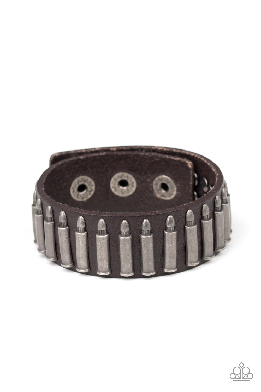 Studded in tin finished bullet frames, a thick brown leather band wraps around the wrist for a rustic look. Features an adjustable snap closure.