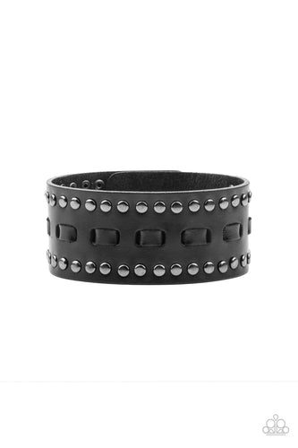 Black laces are threaded through the center of a black leather band that has been studded in gunmetal accents, creating a rustic centerpiece around the wrist. Features an adjustable snap closure.  Sold as one individual bracelet.