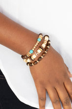 Load image into Gallery viewer, A mismatched collection of brown wooden beads, gold accents, turquoise stones, and glassy beads are threaded along stretchy bands, creating colorful layers around the wrist.  Sold as one set of three bracelets.
