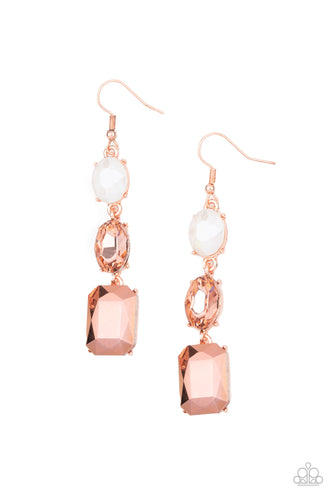 A coppery aurum emerald style gem swings from the bottom of a mismatched pair of coppery and icy opalescent oval rhinestones, creating a stellar lure. Earring attaches to a standard fishhook fitting.  Sold as one pair of earrings.