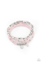 Load image into Gallery viewer, A glimmering collection of silver discs, silver cube beads, and opaque pink crystal-like beads are threaded along stretchy bands around the wrist, creating icy layers. A matching opaque crystal and white rhinestone encrusted charm swing from the display for a whimsical finish.
