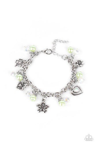 Infused with Green Ash pearls and iridescent crystal-like beads, mismatched silver charms, including a clover, butterfly, heart, and floral frames, swing from a chunky silver chain around the wrist. Features an adjustable clasp closure.  Sold as one individual bracelet.