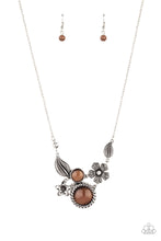 Load image into Gallery viewer, Dotted with brown cat&#39;s eye stones and dainty white rhinestones, mismatched floral frames connect below the collar for a whimsical look. Features an adjustable clasp closure.
