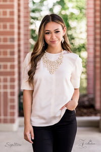 A sparkling storm of classically clustered white rhinestone frames elegantly scatter below the collar. Encased in sleek gold fittings, varied sizes of glassy white rhinestones drip from the bottom of the delicately linked gold frames, resulting in a head-turning twinkle that demands a double take. Features an adjustable clasp closure. 