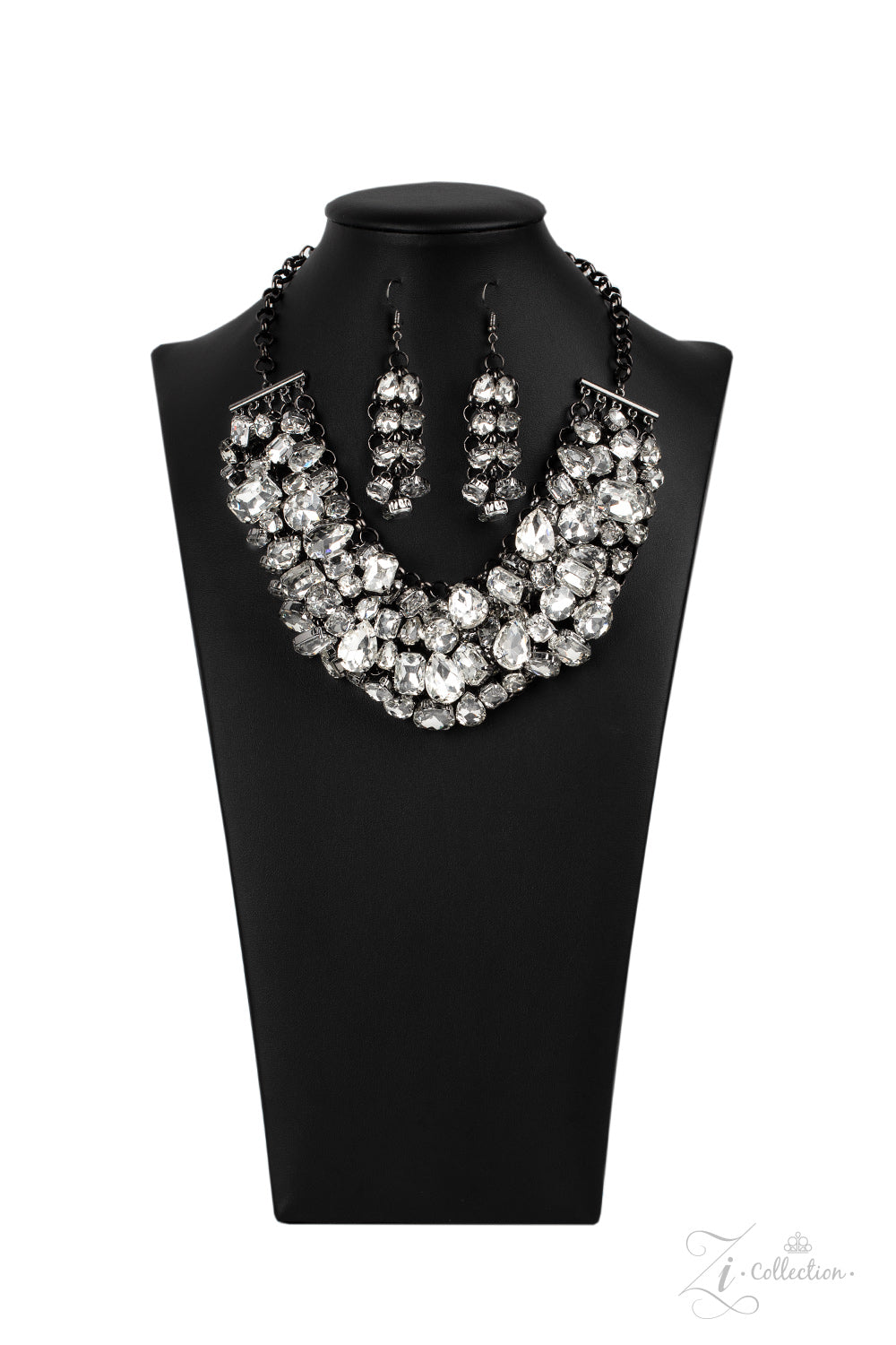 A modern mashup of round, teardrop, and emerald cut white rhinestones link into jam-packed rows of jaw-dropping radiance. Attached to an interconnected gunmetal mesh backdrop, the clustered fringe fabulously drapes below the collar in a spellbinding fashion. Features an adjustable clasp closure.