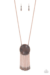 Stamped in a decorative floral pattern, an imperfect copper disc swings from the bottom of a lengthened copper chain. Copper chains and hammered copper beads stream from the bottom of the rustic pendant, creating a flirty fringe. Features an adjustable clasp closure.