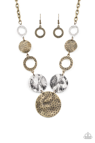 Featuring an array of scratched, hammered, and shiny antiqued finishes, a mismatched collection of imperfect brass and silver discs and hoops delicately connect below the collar to create a rustic statement piece. Features an adjustable clasp closure.