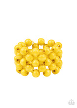 Load image into Gallery viewer, An oversized collection of sunny yellow wooden beads are threaded along stretchy bands that ornately weave across the wrist, creating a decorative summery pattern.

