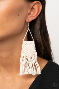 Soft white cording delicately knots and weaves around the bottom of an airy silver triangle, creating a colorful macramé inspired fringe. Earring attaches to a standard fishhook fitting.