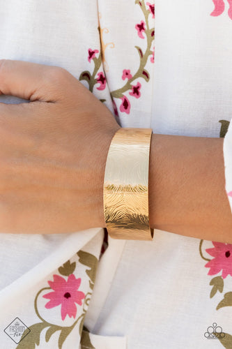 A thick gold band is swirled with rippling textures as it wraps around the wrist into a bold cuff design.  Sold as one individual bracelet.