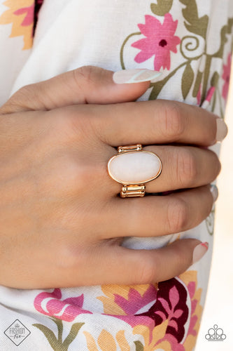 A white oval stone is encased inside a sleek gold frame, creating a mystical centerpiece atop the finger. Features a stretchy band for a flexible fit.  Sold as one individual ring.