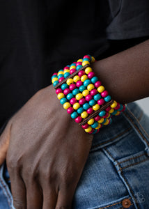 Held together with rectangular wooden fittings, strands of vivacious pink, yellow, and blue wooden beads are threaded along stretchy bands that layer around the wrist into one colorful stretch bracelet.