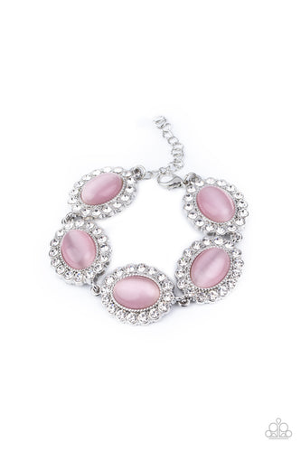 Dotted with glowing pink cat's eye stone centers, glassy white rhinestone encrusted frames glamorously link around the wrist in a sparkly statement-making fashion. Features an adjustable clasp closure.