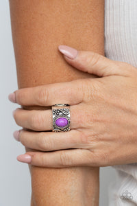 Embossed in leafy floral patterns, the center of a thick silver band is adorned with an oval purple stone for a seasonal flair. Features a stretchy band for a flexible fit.