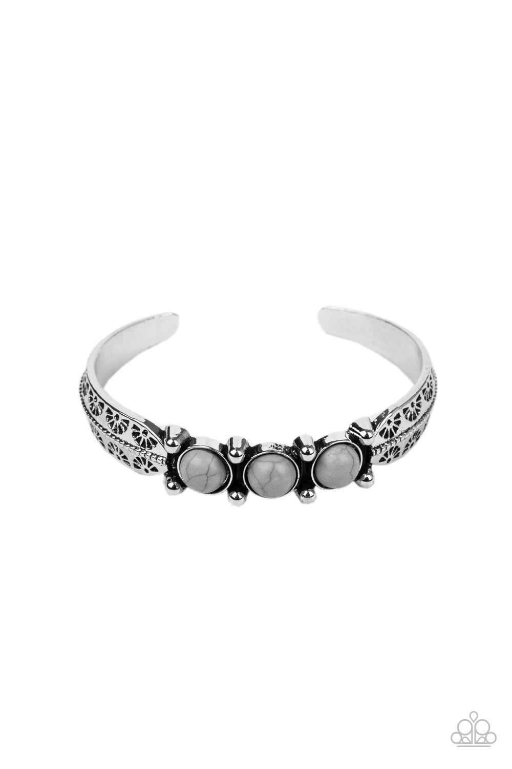 A trio of earthy Sleet stones are encrusted along the center of a dainty silver studded cuff stamped in tribal inspired details for a seasonal flair.