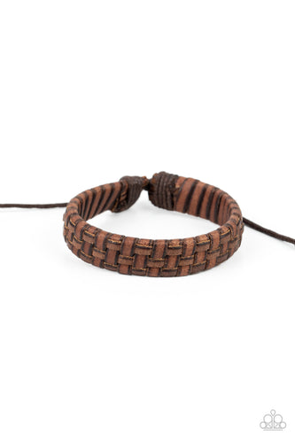 Rustic leather laces weave around a leather band around the wrist, creating a rustic display. Features an adjustable sliding knot closure. 