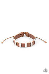 Pieces of white twine-like cording knot around a brown leather band, creating a rustic look around the wrist. Features an adjustable sliding knot closure