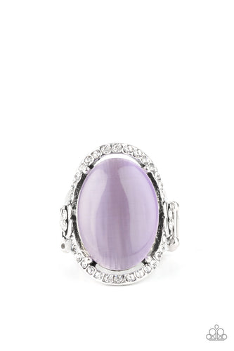 An oval Amethyst Orchid cat's eye stone is nestled inside a ring of white rhinestones featuring dainty heart details, creating a charming centerpiece atop the finger. Features a stretchy band for a flexible fit.