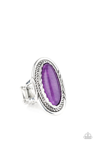An oblong purple stone is pressed into the center of an oval silver frame stamped and embossed in mismatched patterns for a seasonal flair. Features a stretchy band for a flexible fit. 