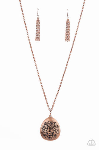 Embossed in a flowery mandala-like pattern, an asymmetrical copper teardrop frame swings from the bottom of a lengthened copper chain for a rustic flair. Features an adjustable clasp closure. 