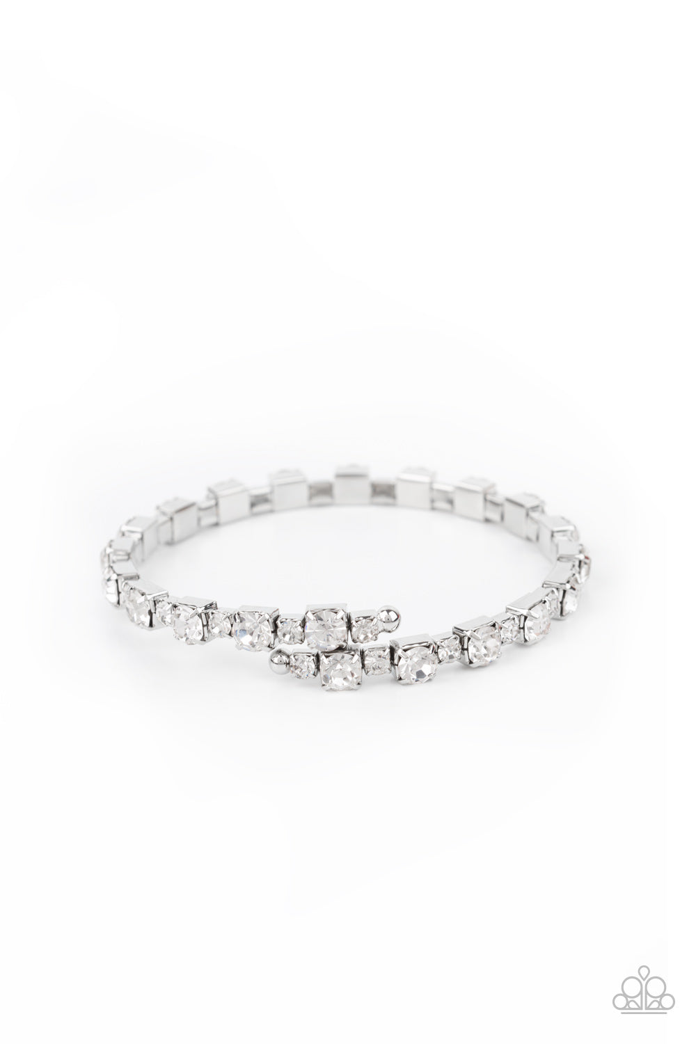 Featuring silver square fittings, dainty and classic white rhinestones delicately alternate along a flexible wire, coiling into a glamorous centerpiece around the wrist.