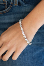 Load image into Gallery viewer, Featuring silver square fittings, dainty and classic white rhinestones delicately alternate along a flexible wire, coiling into a glamorous centerpiece around the wrist.
