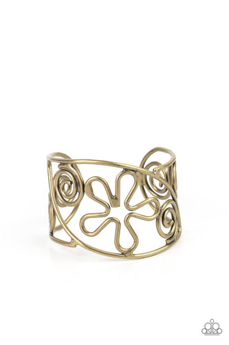 Antiqued brass wire bends and curls into groovy floral and swirl frames, coalescing into a psychedelic cuff around the wrist.
