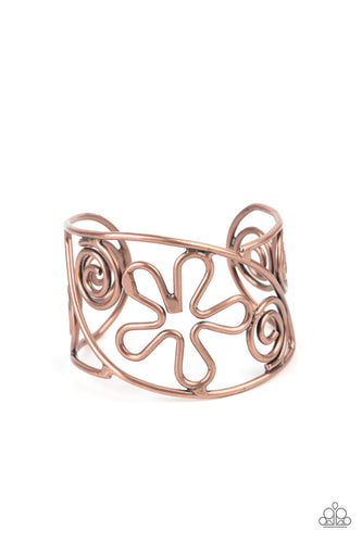 Antiqued copper wire bends and curls into groovy floral and swirl frames, coalescing into a psychedelic cuff around the wrist. 