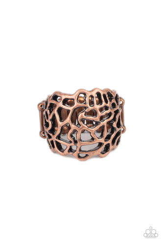 Frilly antiqued copper filigree connects into an asymmetrical stenciled frame across the finger, creating an edgy centerpiece. Features a stretchy band for a flexible fit.