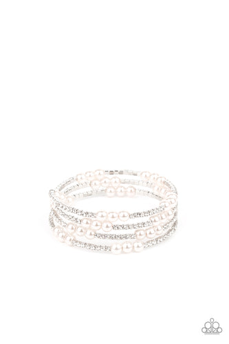 Sparkly sections of glassy white rhinestones and classic pearls are delicately threaded along a coiled wire, creating a glamorous infinity wrap style around the wrist.