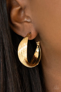 A stack of shiny gold hoops delicately twists at the center, creating a curvaceous display. Earring attaches to a standard post fitting. Hoop measures approximately 1 1/4" in diameter.