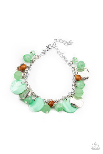 Infused with wooden beads and silver discs, an earthy collection of glassy, opaque, and shell-like Green Ash beads swing from the wrist, creating a springtime inspired fringe. Features an adjustable clasp closure.