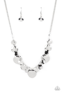 Featuring diamond shaped silver fittings, a mismatched collection of hammered silver discs swings from a classic silver chain below the collar for an eye-catching finish. Features an adjustable clasp closure.