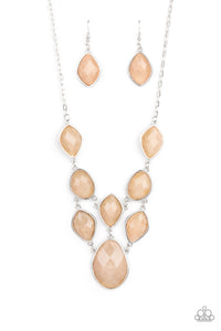 Featuring faceted surfaces, an asymmetrical collection of cloudy Desert Mist faux stone beads are pressed into sleek silver frames as they link into a mystical netted display below the collar. Features an adjustable clasp closure.