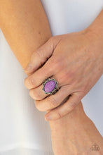 Load image into Gallery viewer, An oval purple stone is pressed into the center of a silver studded floral frame, creating a colorful centerpiece atop the finger. Features a stretchy band for a flexible fit.
